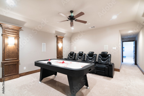 Traditional Media Game Room with leather chairs and air hockey table