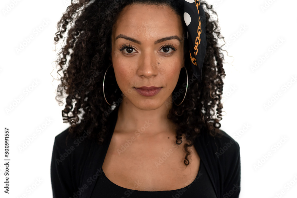 Isolated portrait of a latin woman with curly hair dressed in black Isolated portrait of a latin woman with curly hair dressed in black