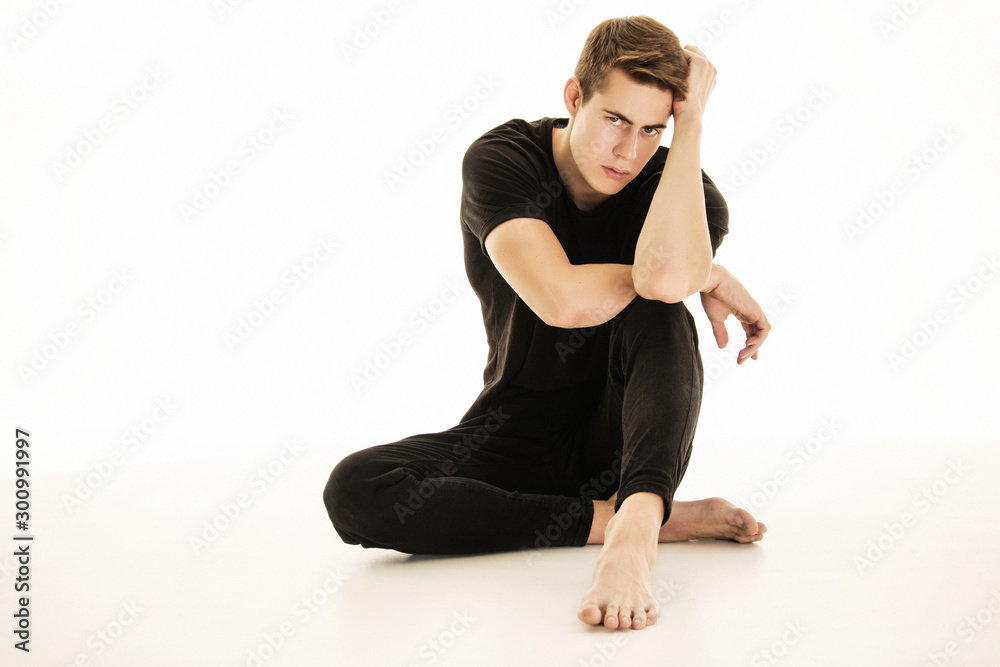 Muscle strong beautiful stripped male model in denim jeans and black t-shirt with belt on white isolated font background