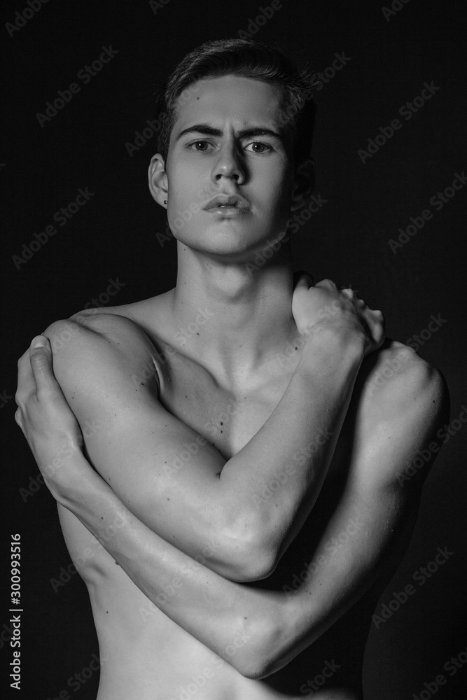 Black and White Handsome sport sexy stripped guy portrait with white underwear on isolated black background 