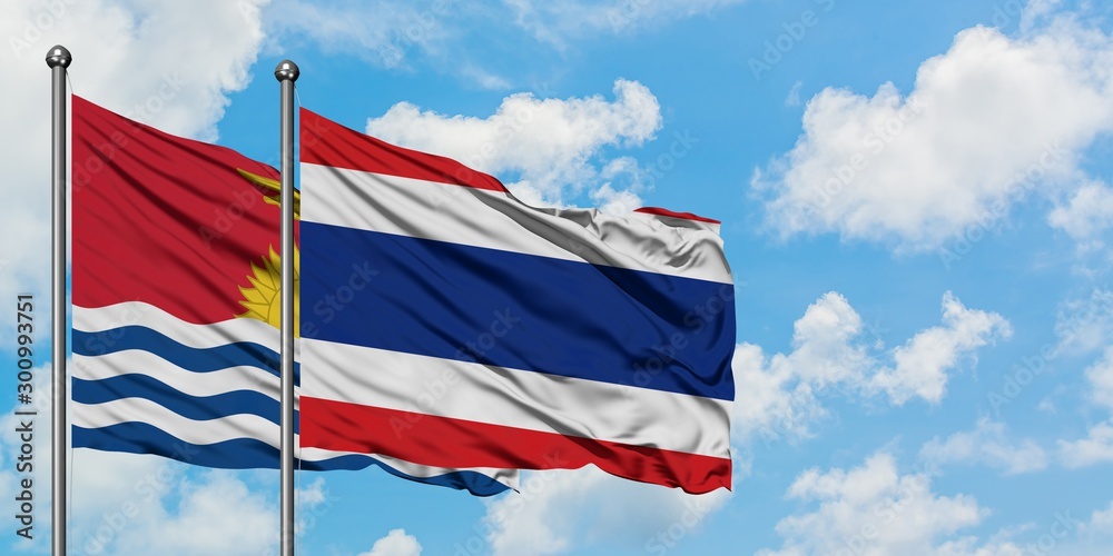 Kiribati and Thailand flag waving in the wind against white cloudy blue sky together. Diplomacy concept, international relations.