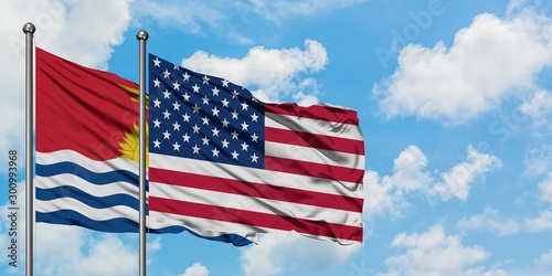 Kiribati and United States flag waving in the wind against white cloudy blue sky together. Diplomacy concept  international relations.