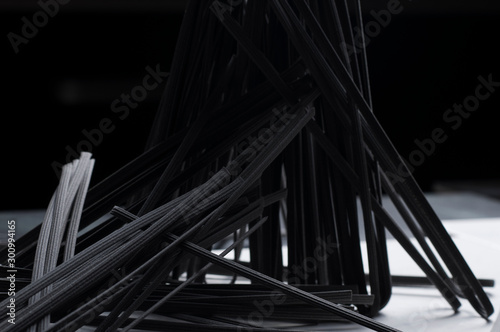 Italian spaghetti close-up shooting.Background texture.black spaghetti.