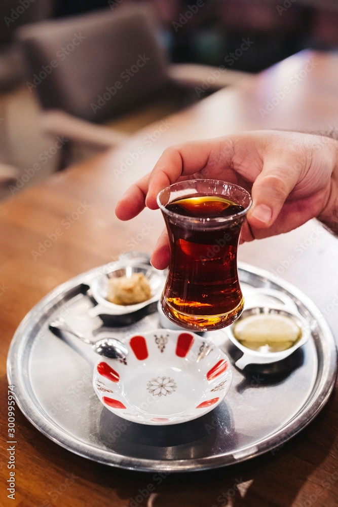 Holding a traditional Turkish Tea Glass Stock Photo | Adobe Stock