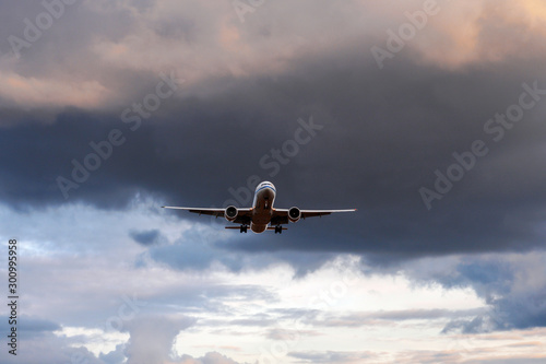  A soaring plane amid a thunderstorm sky.