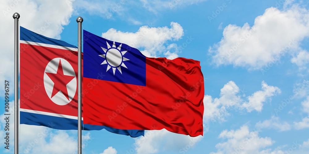 North Korea and Taiwan flag waving in the wind against white cloudy blue sky together. Diplomacy concept, international relations. North Korea and Taiwan flag waving in the wind against white cloudy blue sky together. Diplomacy concept, international relations.