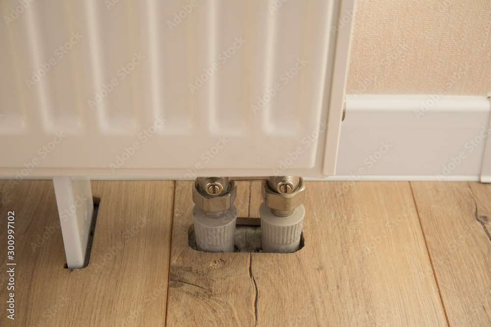 The heating battery is installed in the wooden laminate floor The heating battery is installed in the wooden laminate floor