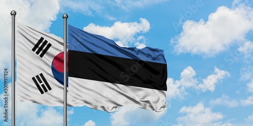 South Korea and Estonia flag waving in the wind against white cloudy blue sky together. Diplomacy concept, international relations.