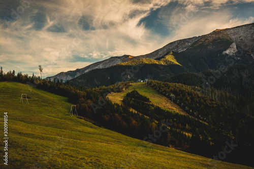 High rocky mountains against the background of the setting sun. Zdiar in Slovakia, high Bielanske Tatras. Trip to the mountains, climbing, hiking in the mountains. Tourists in the mountains.