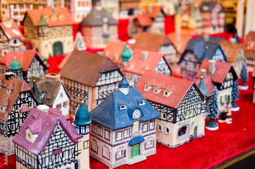 Festive decorations ceramic houses on european Christmas market.