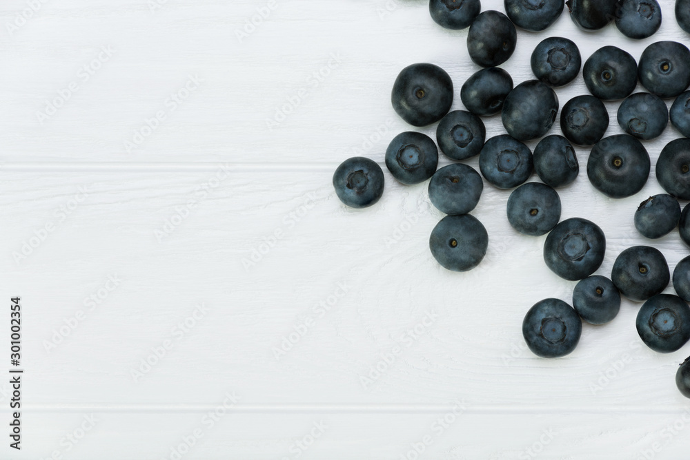 Blueberries on white wooden background. Healthy food. Place for label Blueberries on white wooden background. Healthy food. Place for label