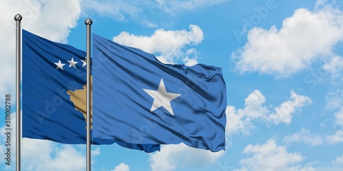 Kosovo and Somalia flag waving in the wind against white cloudy blue sky together. Diplomacy concept, international relations.