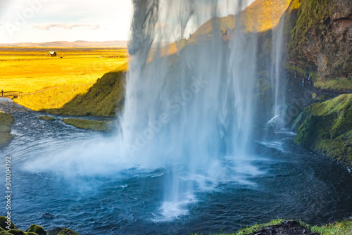 Seljalandfoss waterfall in sunny autumn day, Iceland. Famous tourist attraction