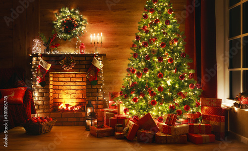 interior christmas. magic glowing tree, fireplace, gifts in  dark