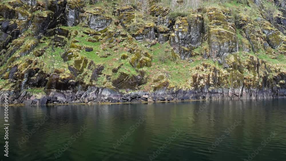 Wall of the fjord in Norway, View on yacht from yacht board sailing along Lofoten Islands, gulls on the rocks Wall of the fjord in Norway, View on yacht from yacht board sailing along Lofoten Islands, gulls on the rocks