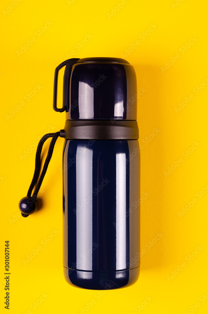 Dark thermos composition on yellow background. Flat lay Stock Photo | Adobe  Stock