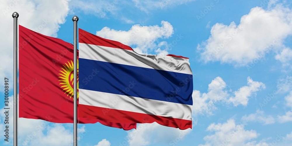 Kyrgyzstan and Thailand flag waving in the wind against white cloudy blue sky together. Diplomacy concept, international relations.