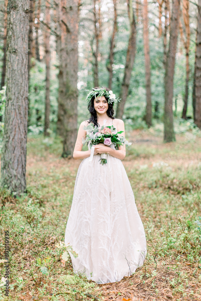stylish bride posing with bouquet on background of forest, luxury gorgeous boho wedding at forest outdoors stylish bride posing with bouquet on background of forest, luxury gorgeous boho wedding at forest outdoors