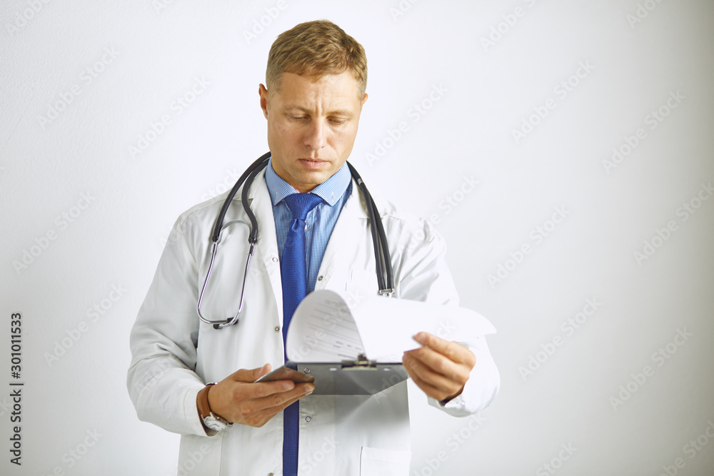 Young confident doctor in a white coat with a stethoscope Young confident doctor in a white coat with a stethoscope
