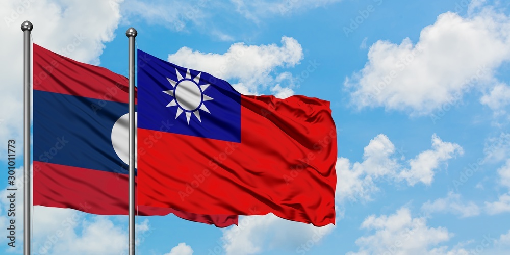 Laos and Taiwan flag waving in the wind against white cloudy blue sky together. Diplomacy concept, international relations. Laos and Taiwan flag waving in the wind against white cloudy blue sky together. Diplomacy concept, international relations.