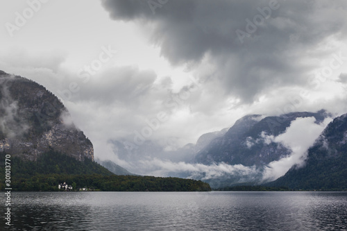 Hallstatt lake in a foggy day and clouds between the mountains
