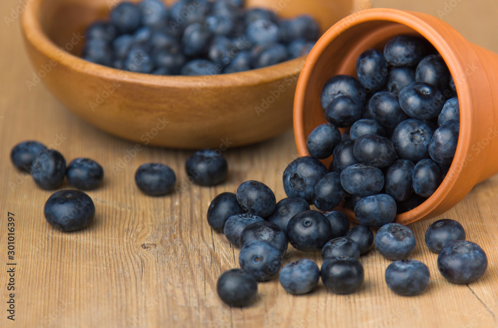 Blueberry on wooden table background. Ripe and juicy fresh picked blueberries closeup. Berries closeup Blueberry on wooden table background. Ripe and juicy fresh picked blueberries closeup. Berries closeup
