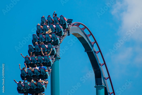 People enjoying riding rollercoaster during summer vacation 48