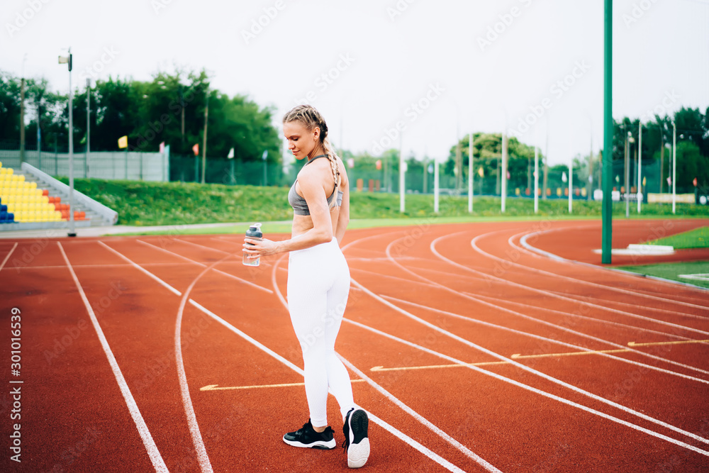 Fototapeta premium Athletic woman running on jogging path
