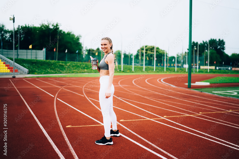 Fototapeta premium Sportswoman smiling while looking at camera
