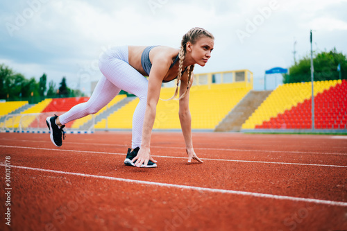 Woman starting running on red track