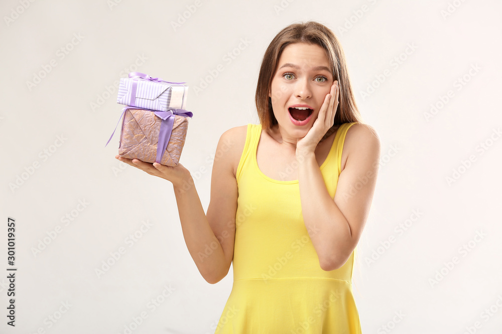 Surprised woman with gift boxes on white background Surprised woman with gift boxes on white background