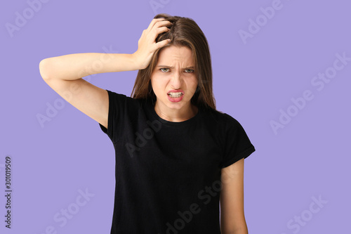 Stressed young woman on color background © Pixel-Shot