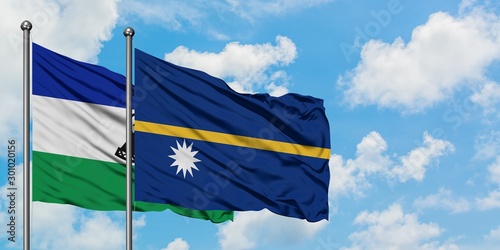 Lesotho and Nauru flag waving in the wind against white cloudy blue sky together. Diplomacy concept, international relations.