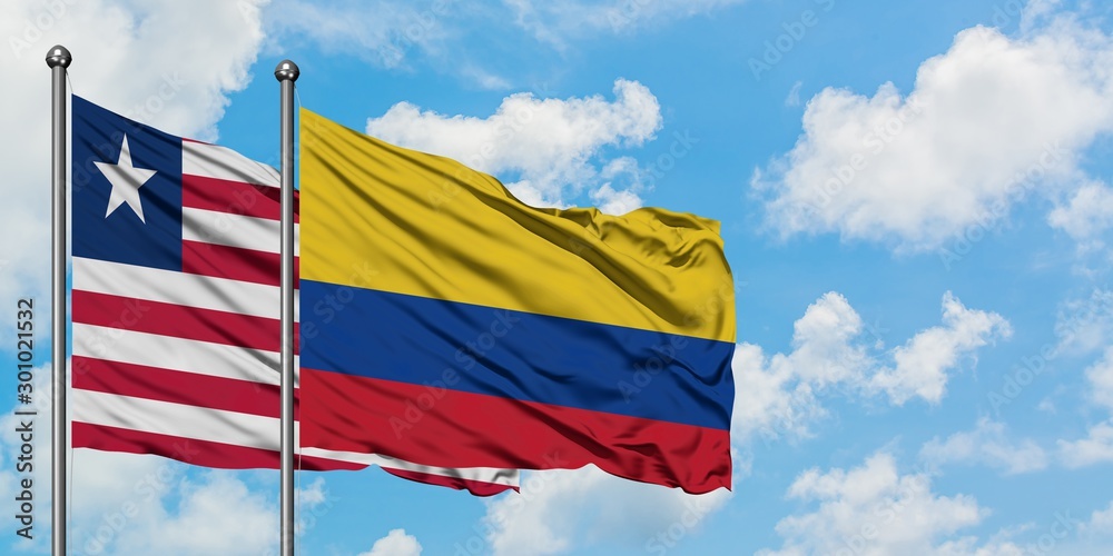 Liberia and Colombia flag waving in the wind against white cloudy blue sky together. Diplomacy concept, international relations.
