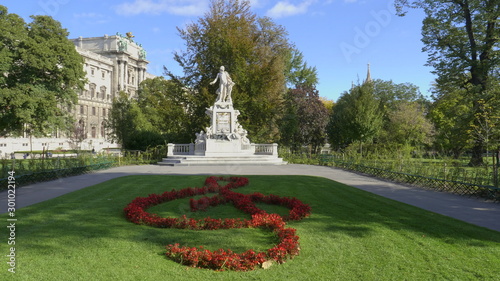 VIENNA, AUSTRIA-OCTOBER, 9, 2017: wide shot of a mozart statue and gardens in vienna, austria