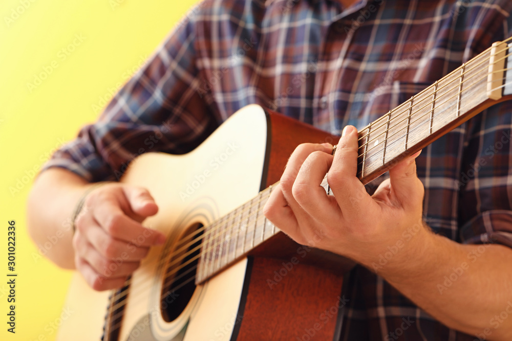 Fototapeta premium Handsome man playing guitar, closeup