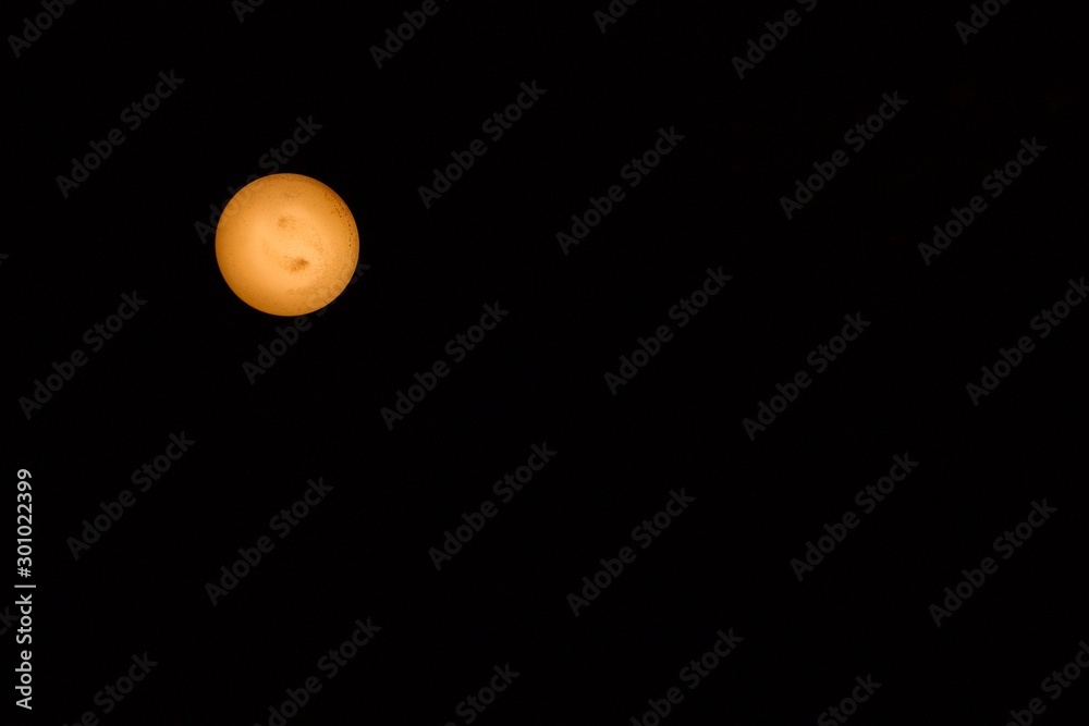 Abstract planet made from a closeup photo of an old used yellow light bulb isolated on black background. Space to copy text Abstract planet made from a closeup photo of an old used yellow light bulb isolated on black background. Space to copy text