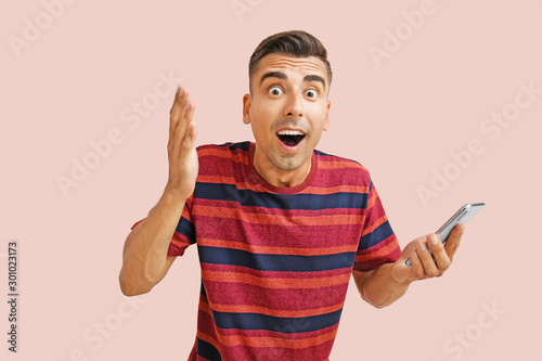 Surprised young man with mo...