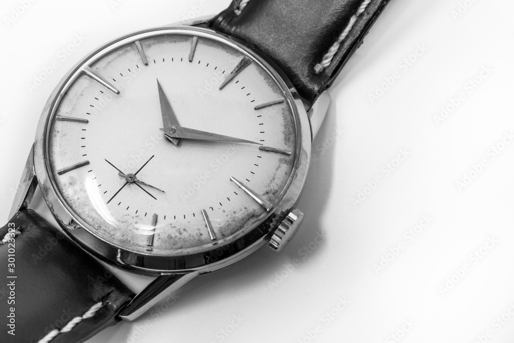 An old gold mechanical wristwatch with manual winding. Antique watch ruined by time, with scratches and mildew stains, rust, oxidation. Leather strap (band). Vintage clock. Spend time. An old gold mechanical wristwatch with manual winding. Antique watch ruined by time, with scratches and mildew stains, rust, oxidation. Leather strap (band). Vintage clock. Spend time.