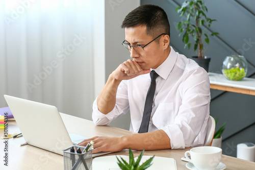 Asian businessman working o...