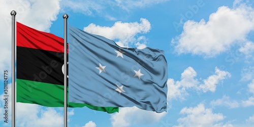 Libya and Micronesia flag waving in the wind against white cloudy blue sky together. Diplomacy concept, international relations.