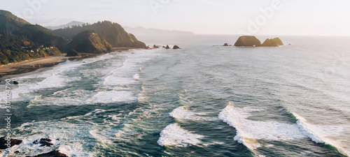 Aerial breathtaking view of wonderful nature landscape, Bird's eye view seashore with big foamy waves with turquoise water in coastal environment. Pacific ocean power, sandy beach of California