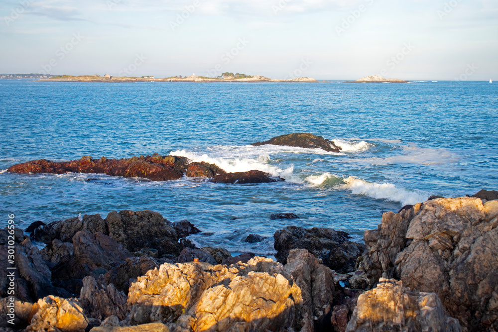 Small waves crashing into rocky shoreline viewed from Chandler Hovey Park in Marblehead, Massachusetts, USA. -01