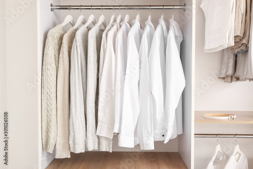 Stylish clothes on hangers in show room