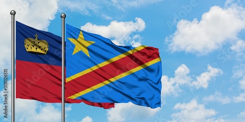 Liechtenstein and Congo flag waving in the wind against white cloudy blue sky together. Diplomacy concept, international relations.