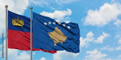 Liechtenstein and Kosovo flag waving in the wind against white cloudy blue sky together. Diplomacy concept, international relations.