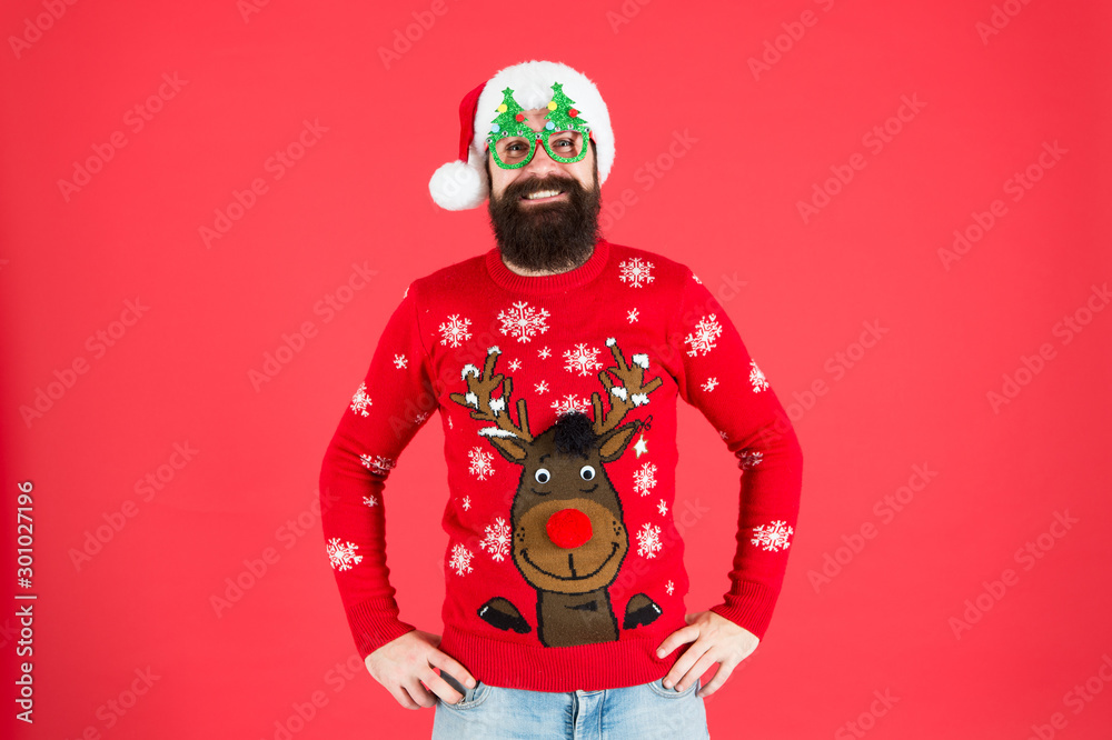 Sweater with deer. Clothes shop. Buy festive clothing. Holidays accessories. Hipster bearded man wear winter sweater and hat. Knitted sweater. Happy new year. Christmas spirit. Winter party outfit