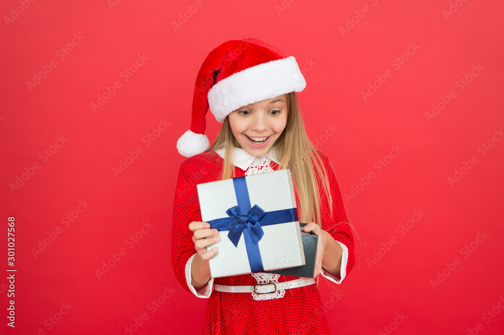 Winter holidays. Gift from Santa. Winter season. Fun time of year that you can easily tackle in a fun and organized manner. Little girl with christmas gift. Shopping concept. Winter tradition Winter holidays. Gift from Santa. Winter season. Fun time of year that you can easily tackle in a fun and organized manner. Little girl with christmas gift. Shopping concept. Winter tradition