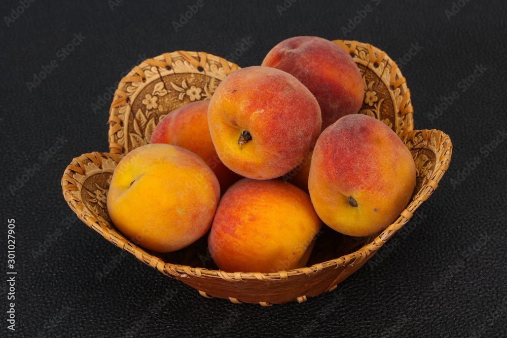 Peach heap in the wooden basket Peach heap in the wooden basket