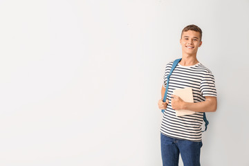 Cool teenage schoolboy on white background